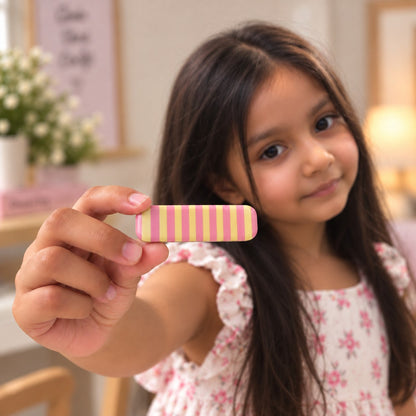 Bubble Mint hair clip by Zootii held in hand: pink and yellow candy-stripe clip