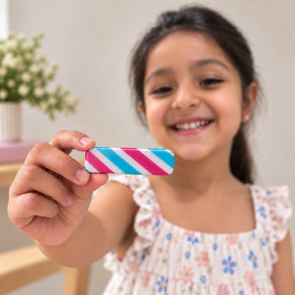 Candy Slant hair clip by Zootii held in hand: pink, blue and white diagonal candy-stripe clip